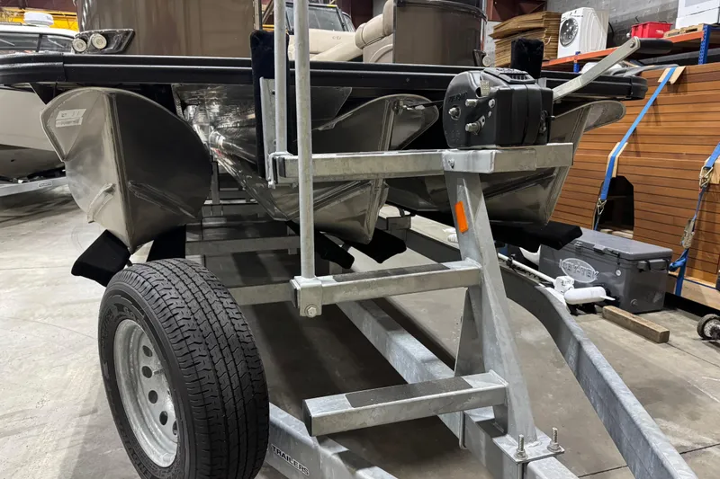 Slide: The Image of 2022 Avalon Catalina Platinum Cruise pontoon boat on a trailer in a warehouse. - 10