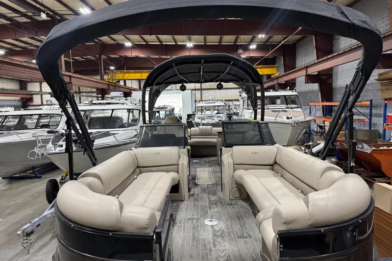 Slide: The Image of 2022 Avalon Catalina Platinum Cruise pontoon boat in a showroom with luxurious seating. - 13