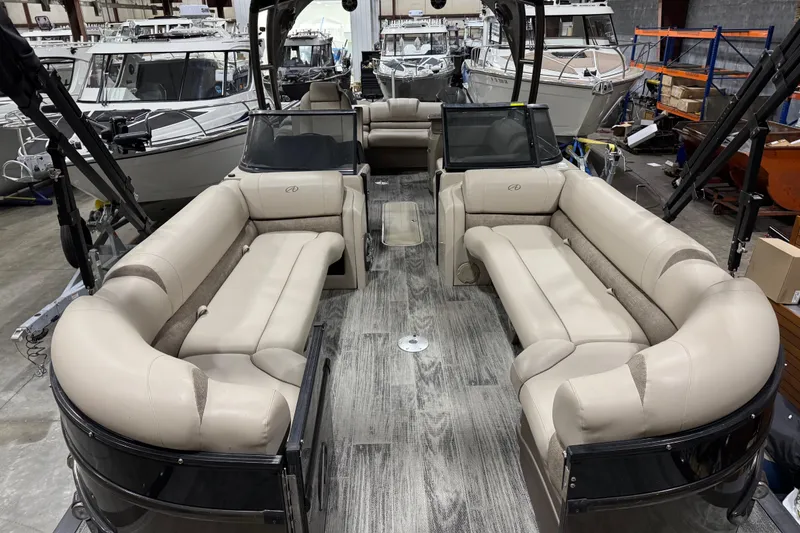 Slide: The Image of 2022 Avalon Catalina Platinum Cruise pontoon boat interior with luxurious seating in a showroom. - 14