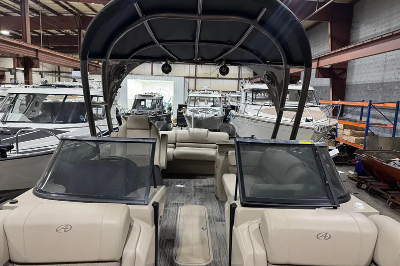 Slide: The Image of 2022 Avalon Catalina Platinum Cruise boat interior in a showroom with other boats. - 15