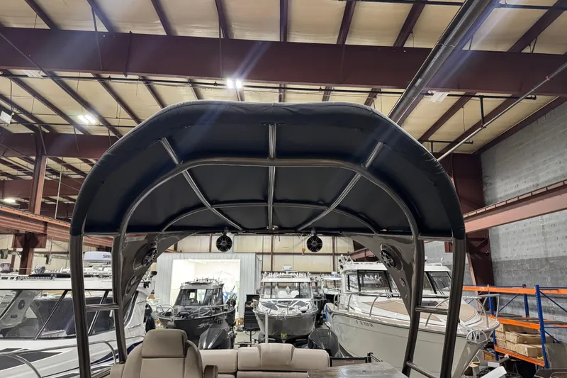 Slide: The Image of 2022 Avalon Catalina Platinum Cruise boat interior with canopy in a showroom. - 16