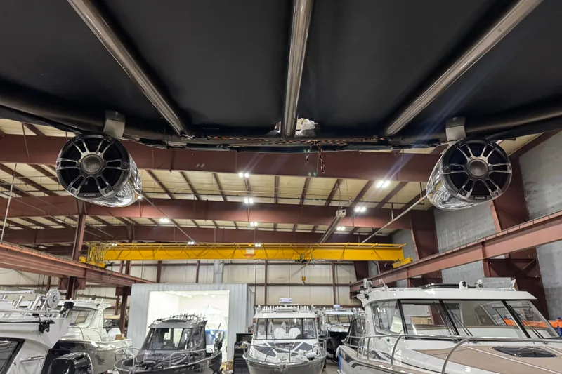Slide: The Image of 2022 Avalon Catalina Platinum Cruise boat in a warehouse with mounted speakers. - 26