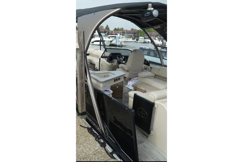 Slide: The Image of 2022 Avalon Catalina Platinum Cruise boat interior with beige seating and steering console. - 41