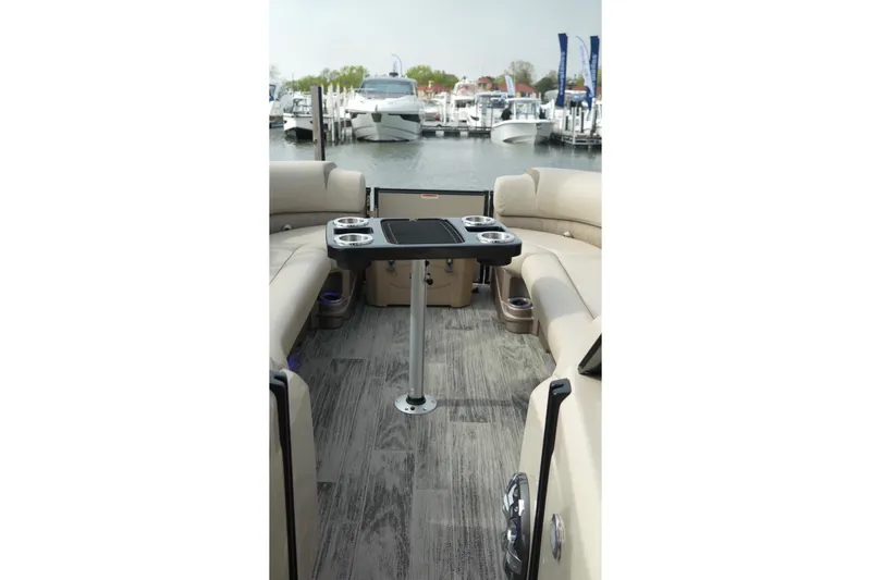 Slide: The Image of 2022 Avalon Catalina Platinum Cruise interior with seating and table, docked at marina. - 47