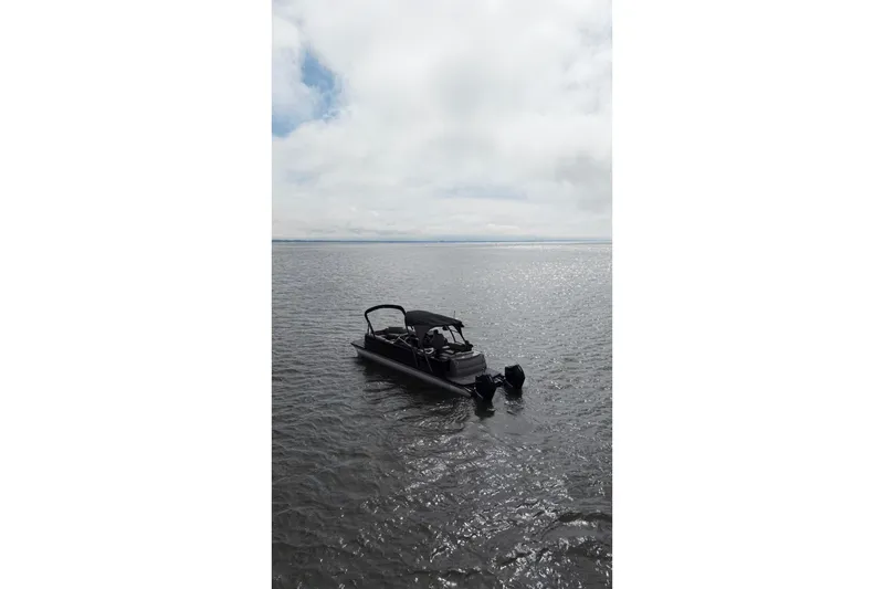 Slide: The Image of 2022 Avalon Catalina Platinum Cruise pontoon boat on calm water under cloudy sky. - 51