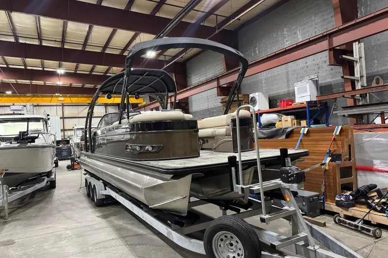 Slide: The Image of 2022 Avalon Catalina Platinum Cruise pontoon boat in a warehouse on a trailer. - 9