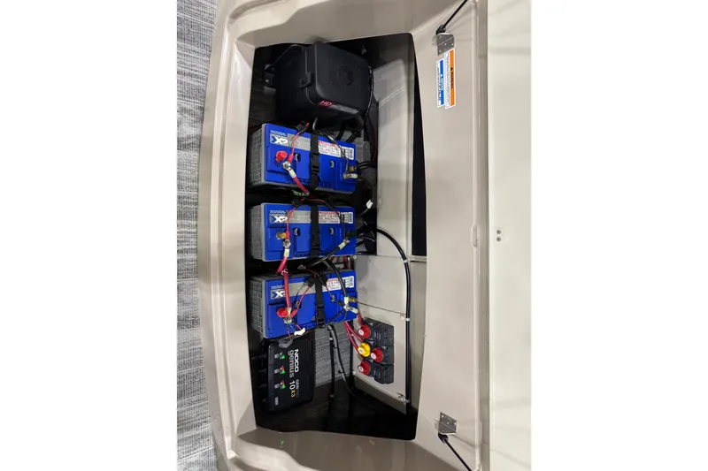 Slide: The Image of Battery compartment of 2022 Avalon Catalina Platinum Cruise with multiple blue batteries and wiring. - 14