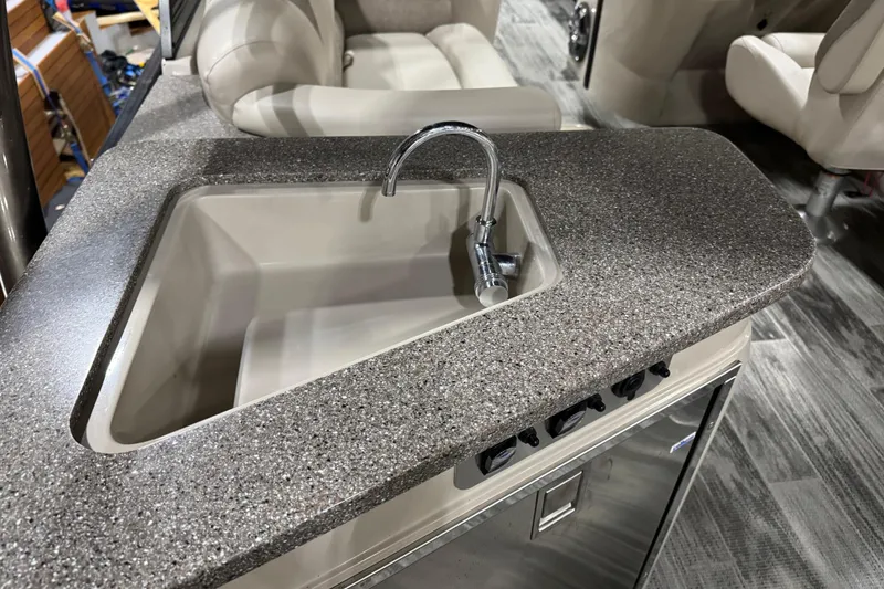 Slide: The Image of 2022 Avalon Catalina Platinum Cruise boat interior with sleek countertop and built-in sink. - 17