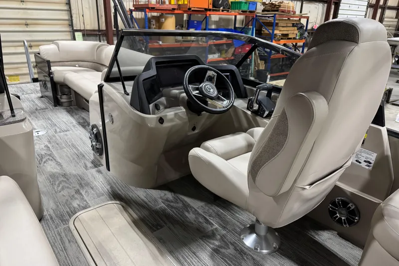 Slide: The Image of 2022 Avalon Catalina Platinum Cruise boat interior with steering wheel and beige seating. - 22