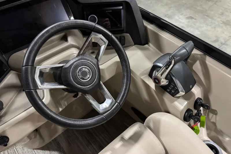 Slide: The Image of Steering wheel and controls of 2022 Avalon Catalina Platinum Cruise boat. - 25