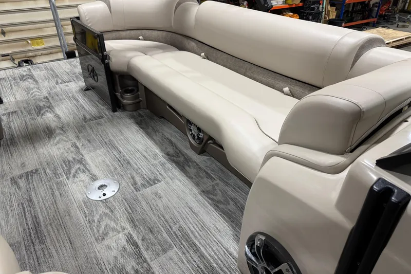 Slide: The Image of 2022 Avalon Catalina Platinum Cruise boat interior with beige seating and gray flooring. - 26