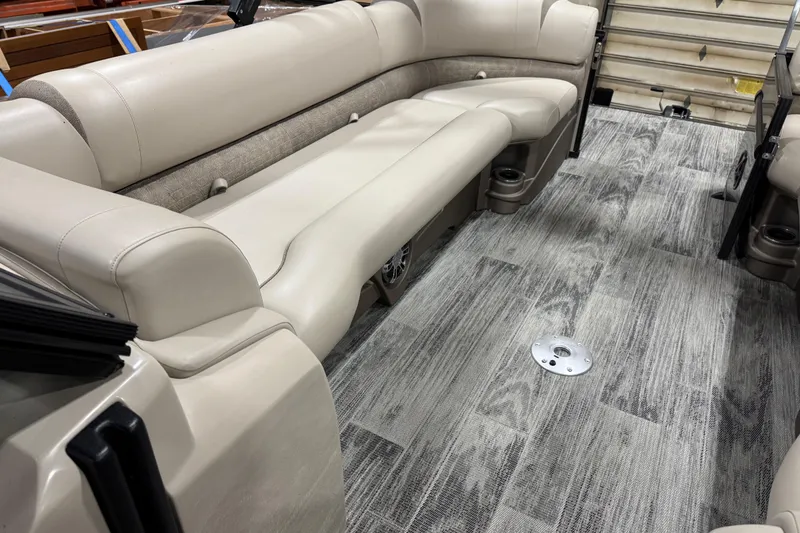 Slide: The Image of 2022 Avalon Catalina Platinum Cruise interior with beige seating and wood-patterned flooring. - 27