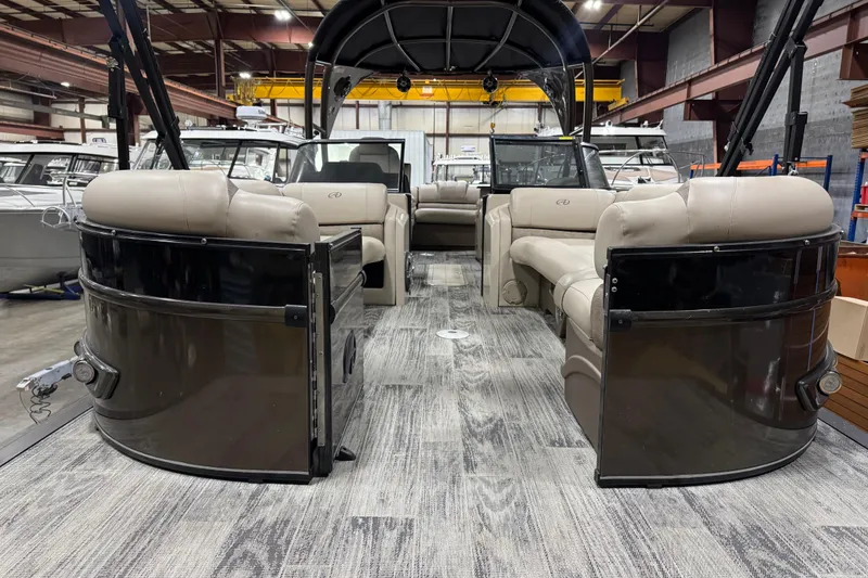 Slide: The Image of 2022 Avalon Catalina Platinum Cruise pontoon boat interior with beige seating in a showroom. - 6