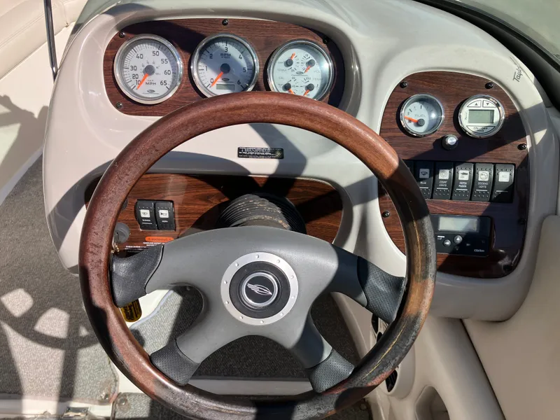 Slide: The Image of Dashboard of a 2008 Chaparral 204 SSi boat with wooden steering wheel. - 12