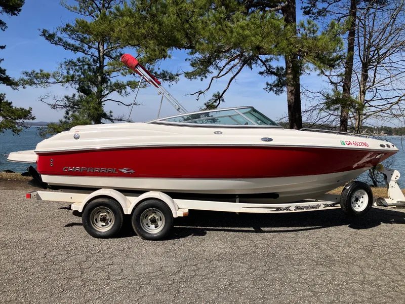 Slide: The Image of 2008 Chaparral 204 SSi boat on trailer, red design, parked outdoors. - 4