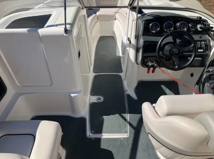 Slide: The Image of Interior of a 2009 Yamaha SX230 boat with steering console. - 11