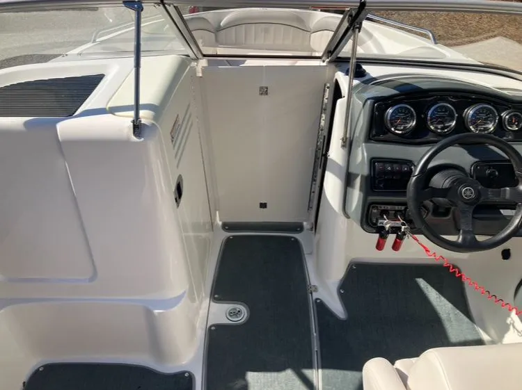 Slide: The Image of Interior of a 2009 Yamaha SX230 boat with steering console. - 12
