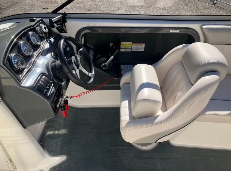 Slide: The Image of Interior of a 2009 Yamaha SX230 boat with steering console. - 14