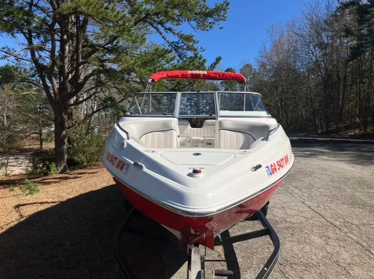 Slide: The Image of 2009 Yamaha SX230 boat parked outdoors on a trailer. - 2