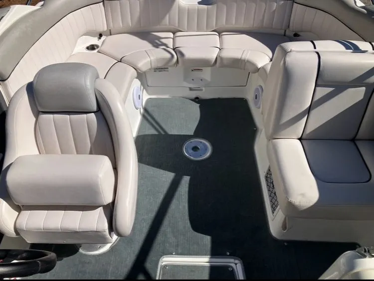 Slide: The Image of Interior of a 2009 Yamaha SX230 boat with beige seating. - 21