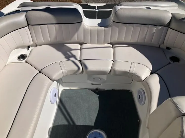 Slide: The Image of Interior of a 2009 Yamaha SX230 boat with cushioned seating. - 22