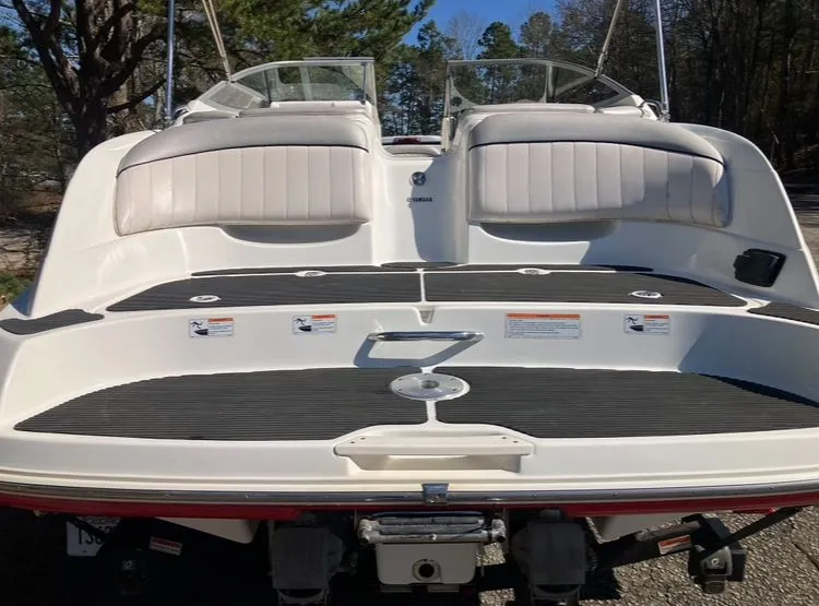 Slide: The Image of Rear view of a 2009 Yamaha SX230 boat with cushioned seats. - 8