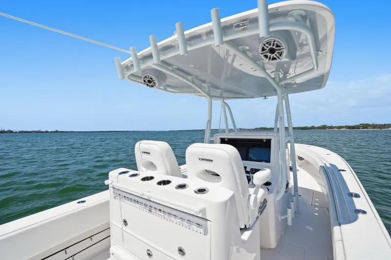 Slide: The Image of 2024 Contender 32 ST boat on open water, featuring sleek design and advanced controls. - 10