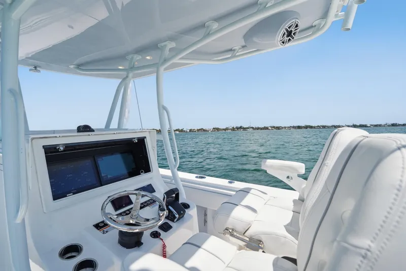 Slide: The Image of 2024 Contender 32 ST boat interior with steering console and ocean view. - 12