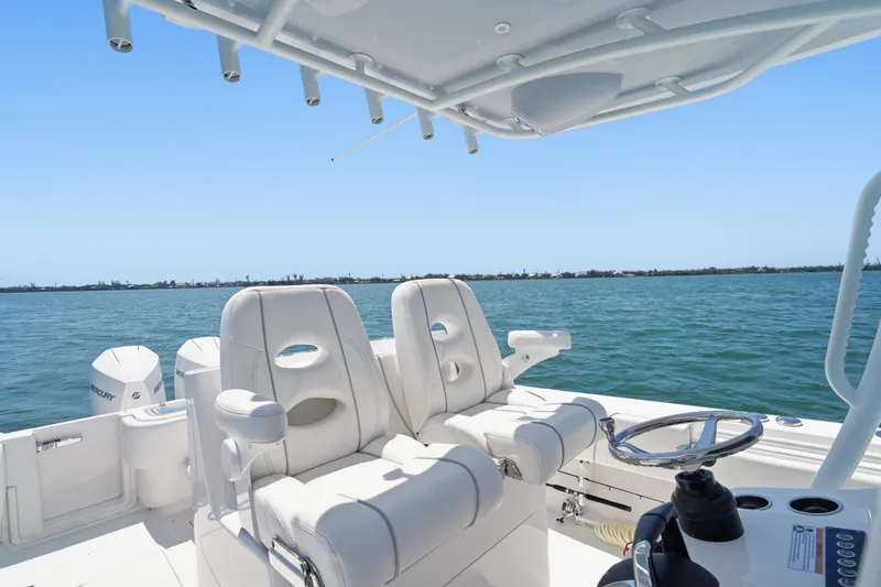 Slide: The Image of 2024 Contender 32 ST boat interior with white seating and ocean view. - 13