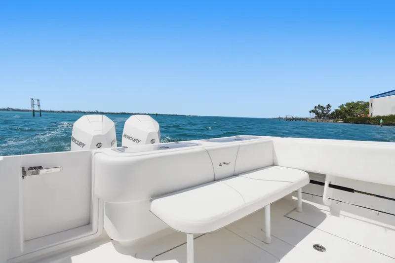 Slide: The Image of 2024 Contender 32 ST boat with dual Mercury engines on open water. - 14