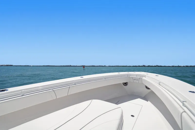 Slide: The Image of 2024 Contender 32 ST boat on open water under clear blue sky. - 15