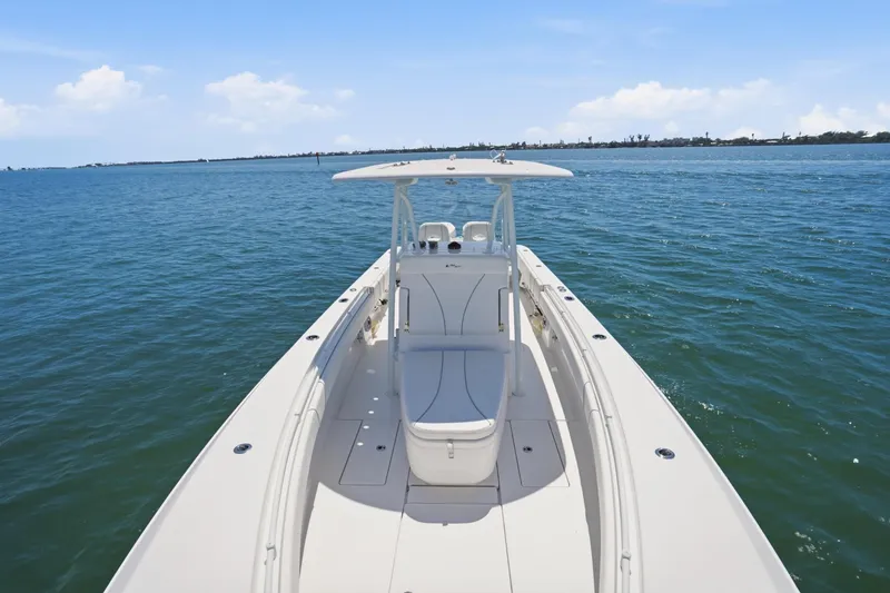 Slide: The Image of 2024 Contender 32 ST boat on open water, showcasing sleek design and spacious deck. - 17