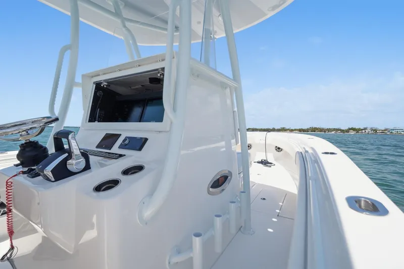 Slide: The Image of 2024 Contender 32 ST boat console with ocean view, showcasing sleek design and advanced controls. - 18