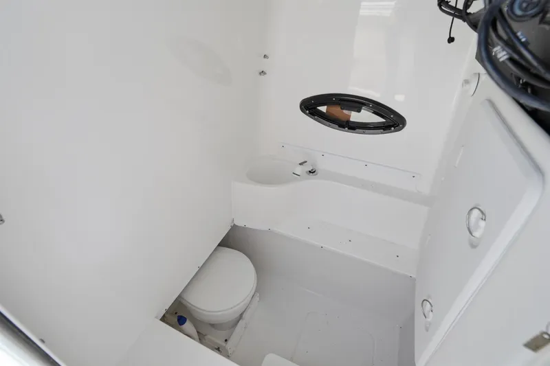 Slide: The Image of 2024 Contender 32 ST boat interior bathroom with toilet and small window. - 20