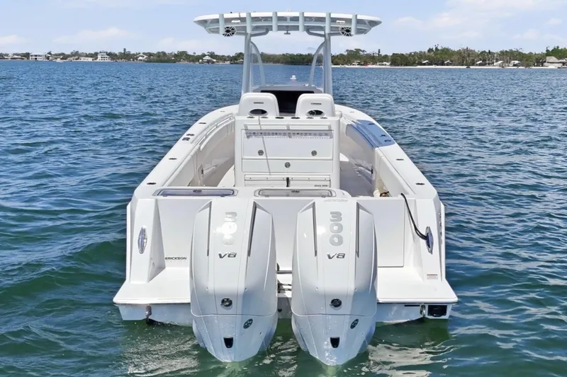 Slide: The Image of 2024 Contender 32 ST boat with dual Mercury 300 V8 engines on open water. - 3
