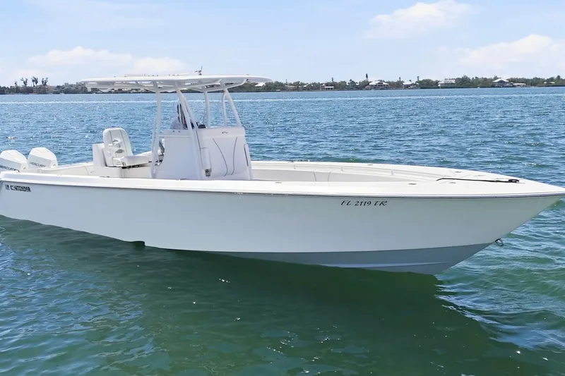 Slide: The Image of 2024 Contender 32 ST boat on calm water, showcasing sleek design and modern features. - 4