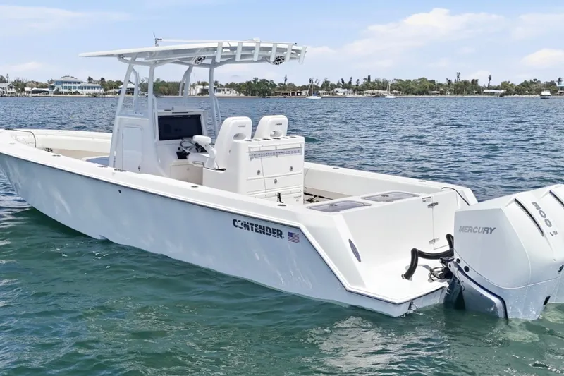 Slide: The Image of 2024 Contender 32 ST boat with Mercury engines on calm water. - 5