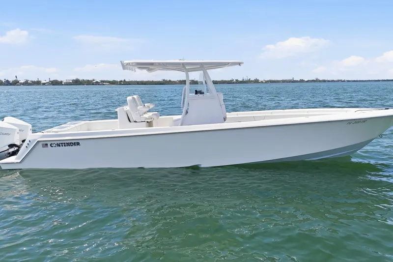 Slide: The Image of 2024 Contender 32 ST boat on calm water under clear sky. - 6