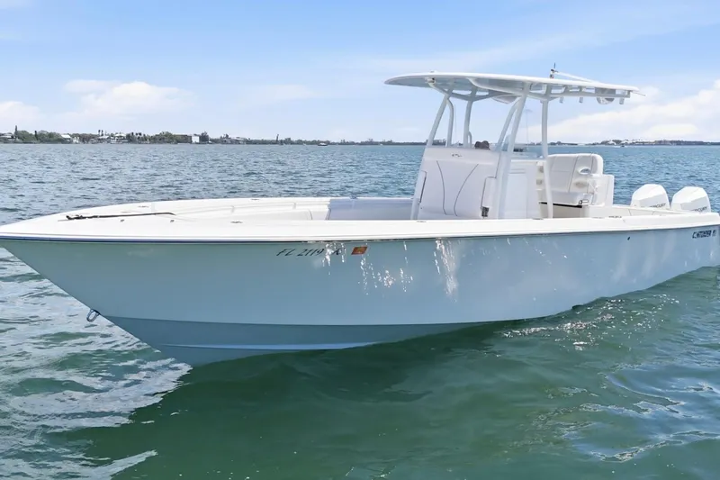 Slide: The Image of 2024 Contender 32 ST boat on calm water, showcasing sleek design and modern features. - 7