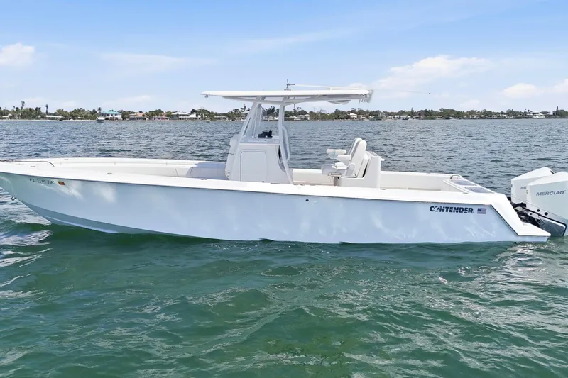 Slide: The Image of 2024 Contender 32 ST boat on water, featuring sleek design and Mercury engines. - 8