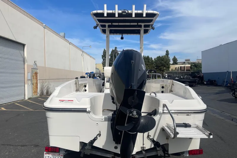 Slide: The Image of 2020 Bayliner Element F18 boat with outboard motor in an industrial area. - 4
