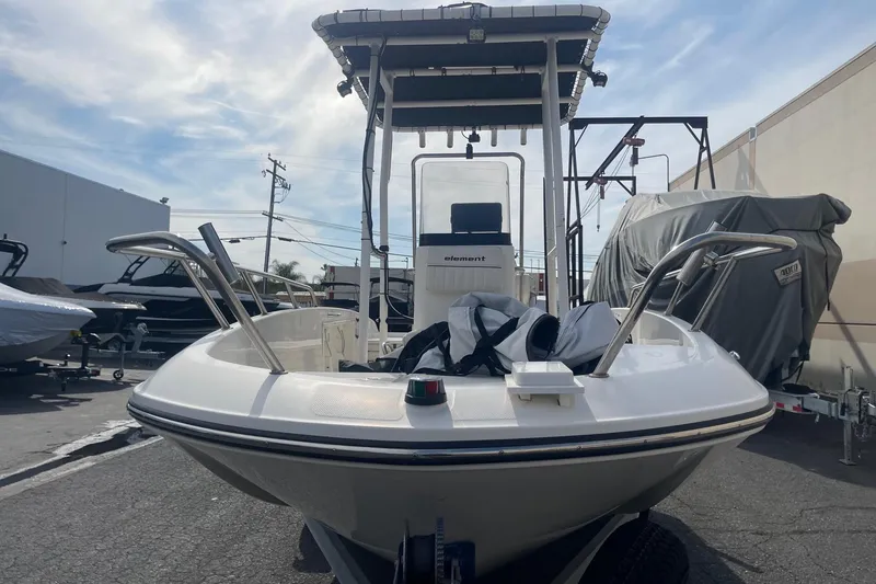 Slide: The Image of 2020 Bayliner Element F18 boat in a marina, showcasing sleek design and modern features. - 5