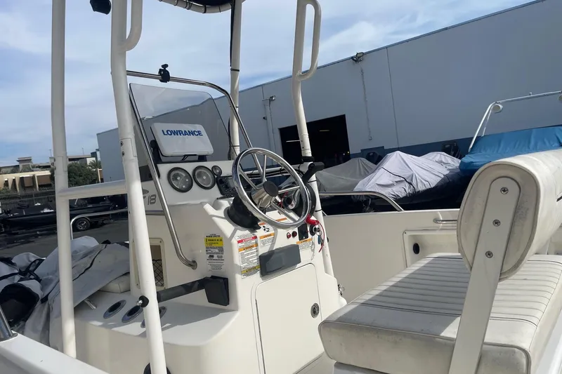 Slide: The Image of 2020 Bayliner Element F18 boat interior with steering wheel and Lowrance equipment. - 6