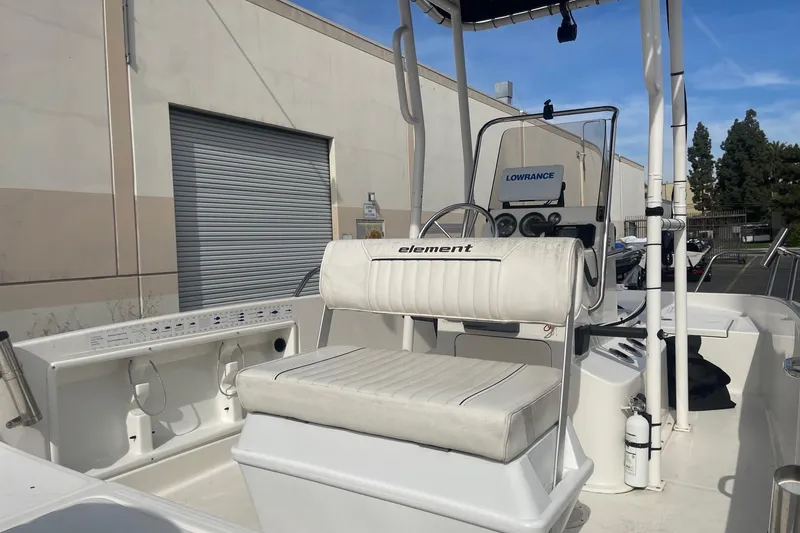 Slide: The Image of 2020 Bayliner Element F18 boat interior with seating and control panel. - 8