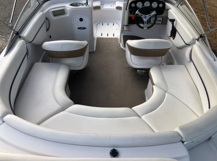 Slide: The Image of Interior of a 2007 Four Winns 204 Funship boat with white seating. - 9