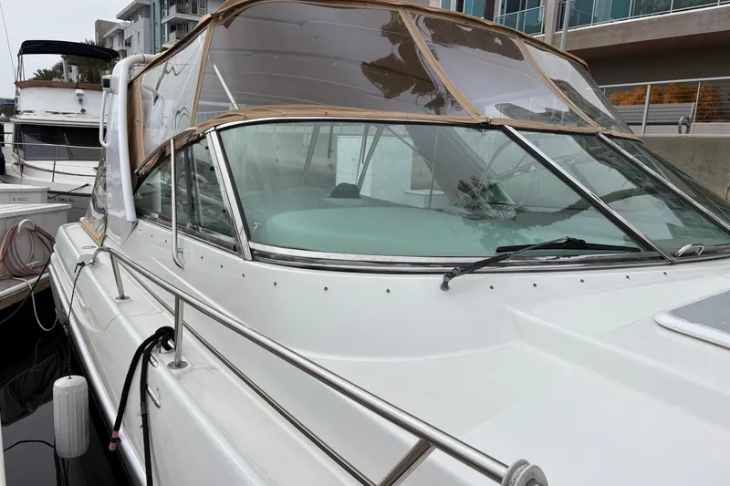 Slide: The Image of 2004 Formula 41 Performance Cruiser docked at marina, featuring sleek design and protective canopy. - 13