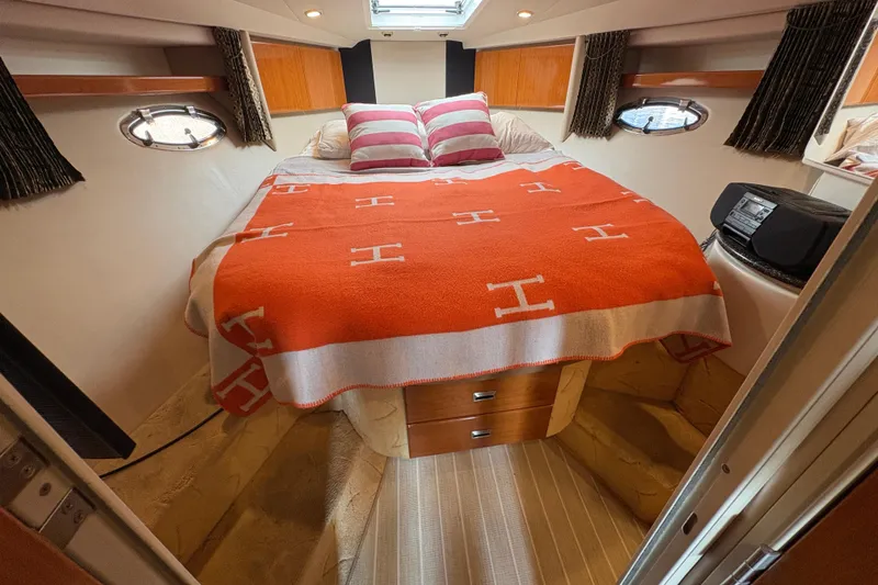 Slide: The Image of Cozy cabin interior of 2004 Formula 41 Performance Cruiser with bed and striped pillows. - 19