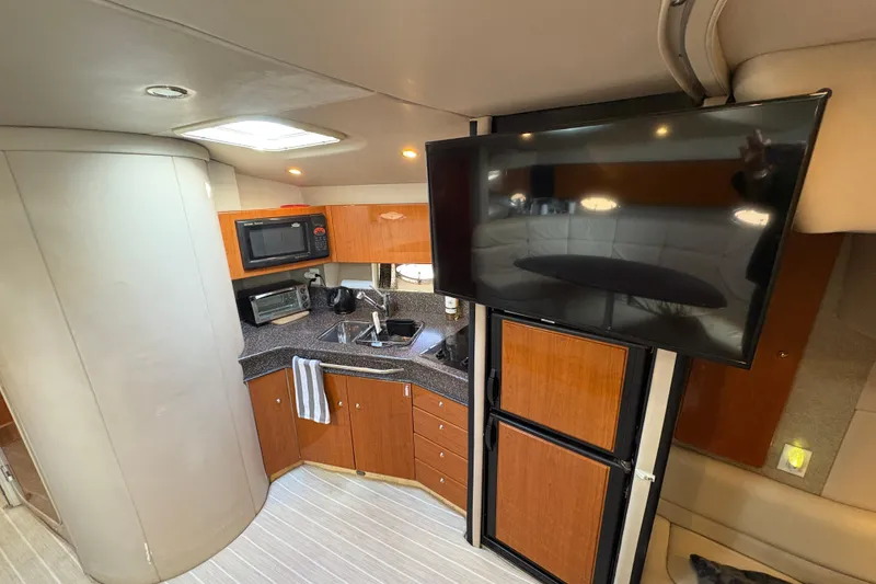 Slide: The Image of Interior of 2004 Formula 41 Performance Cruiser with kitchenette and mounted TV. - 20