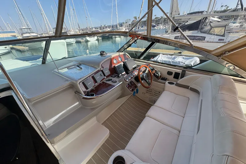 Slide: The Image of 2004 Formula 41 Performance Cruiser cockpit with luxurious seating and modern controls at marina. - 28