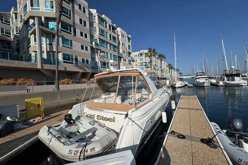 Slide: The Image of 2004 Formula 41 Performance Cruiser docked at marina, modern apartments in background. - 30
